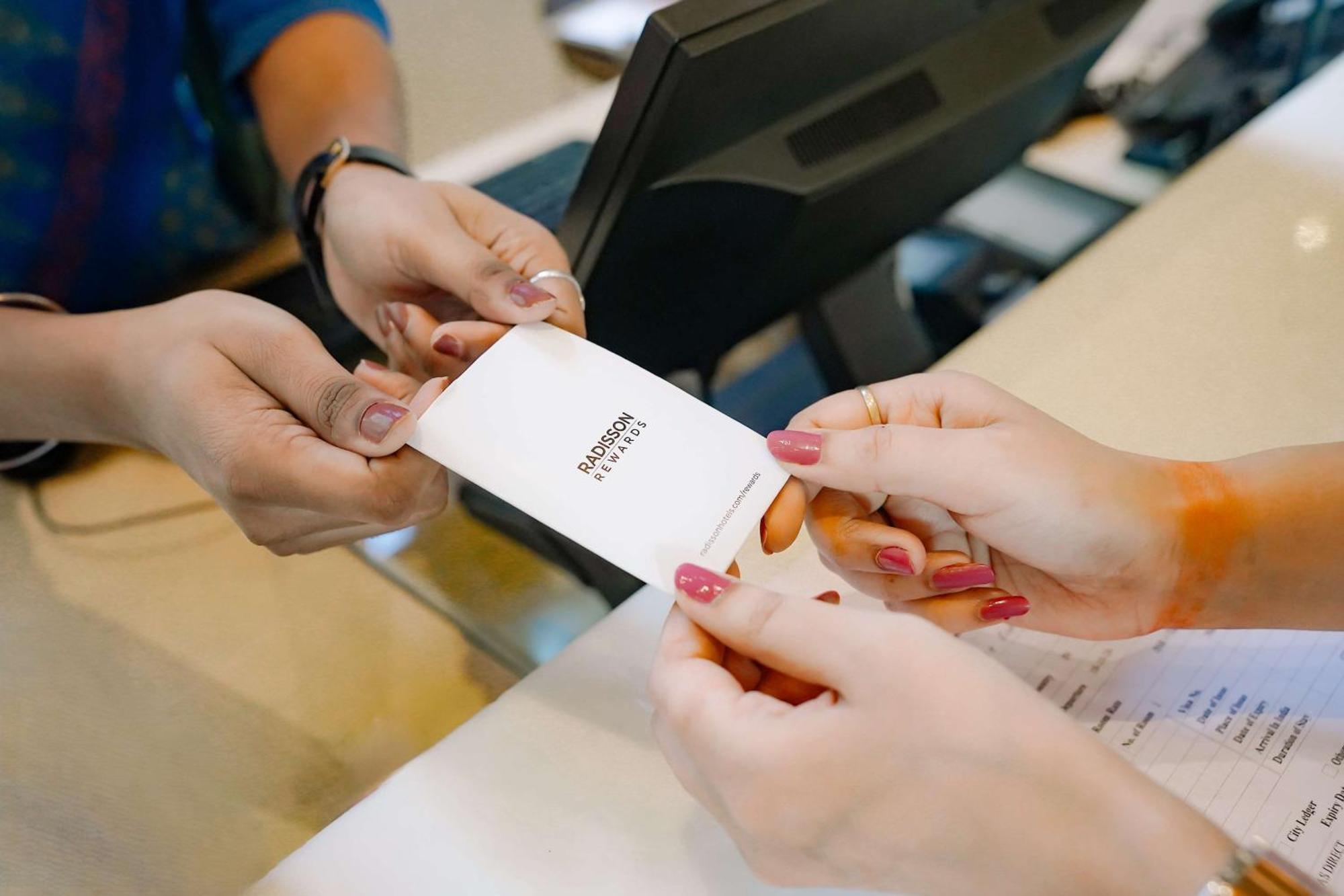 Radisson Blu Hotel Amritsar Bagian luar foto A person's identity is verified with a passport at a border crossing.